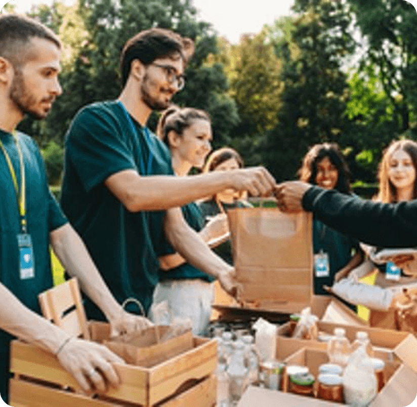 Volunteers handing out food packages outdoors, representing community support and guidance for beginners seeking help with nutrition.